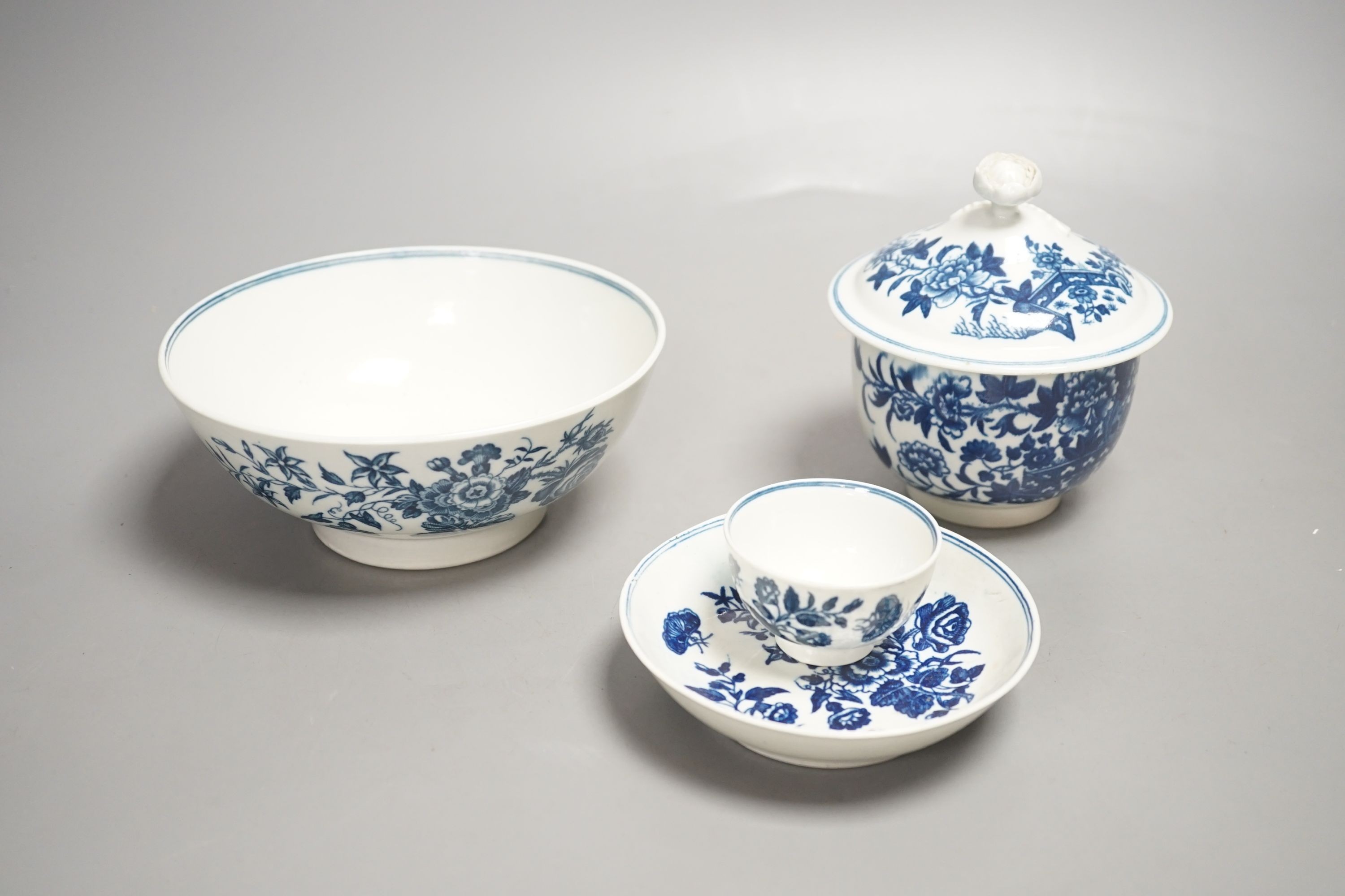 A Worcester sucrier and cover with floral finial printed in blue underglaze with the Fence pattern, Worcester toy size teabowl and saucer, and a Worcester bowl printed with the Three Flowers pattern c.1775-sucrier and co